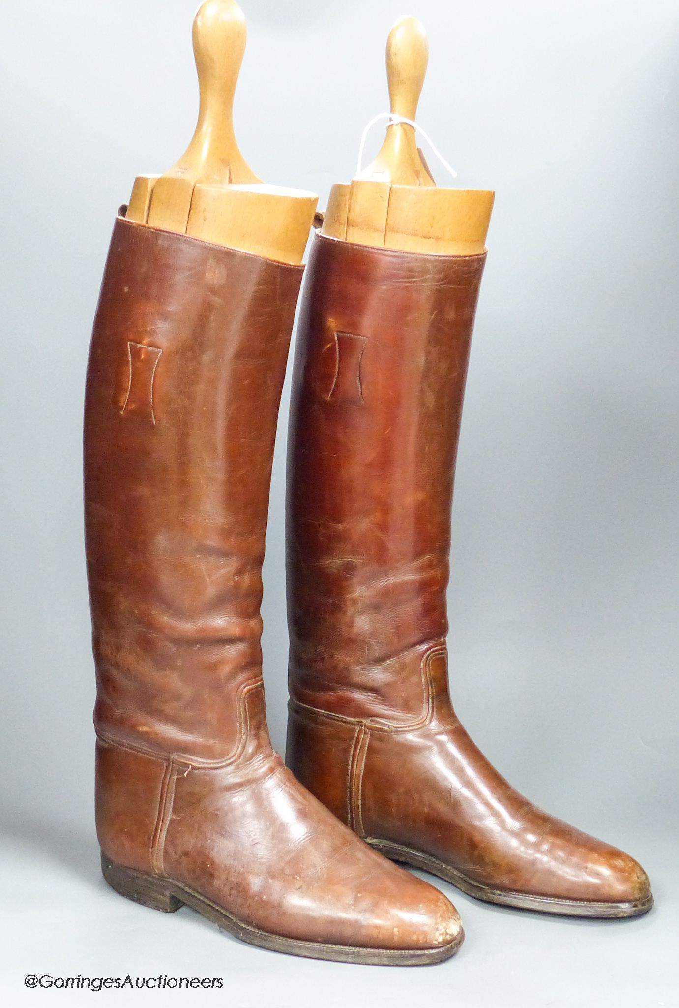 A pair of brown leather riding boots and trees